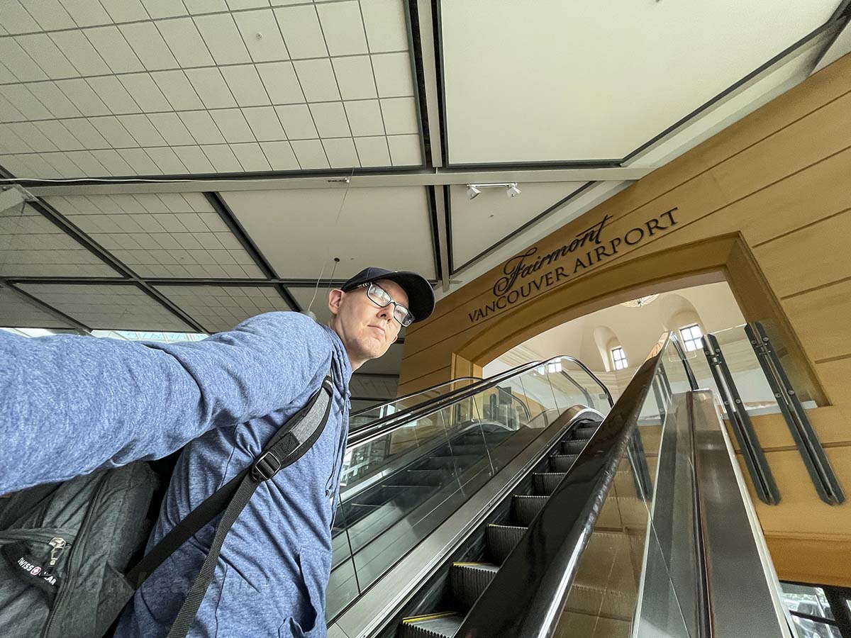 Scott going up the escalator into the Fairmont Hotel at the Vancouver airport