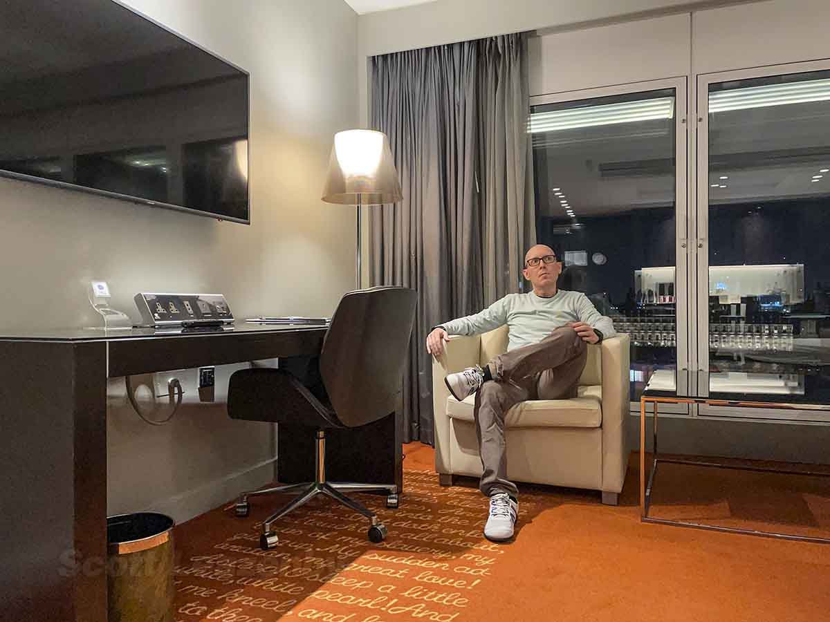 Scott Leazenby sitting in the room at the park plaza Westminster bridge hotel in London