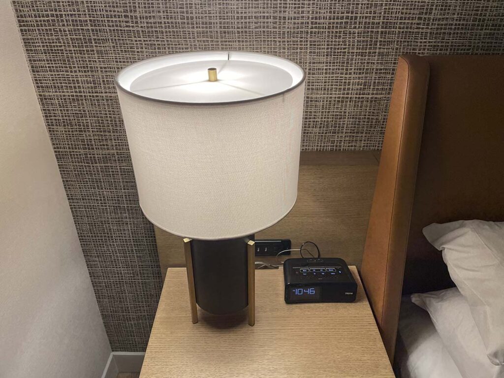 Sheraton YYZ bedside table with alarm clock and lamp