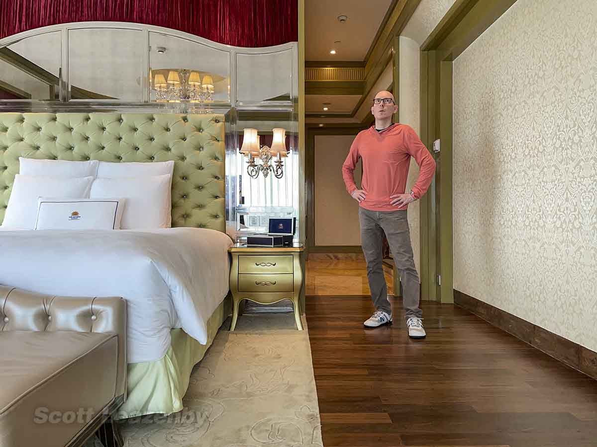 Scarred standing in the Panorama deluxe king room at The Reverie Saigon Hotel
