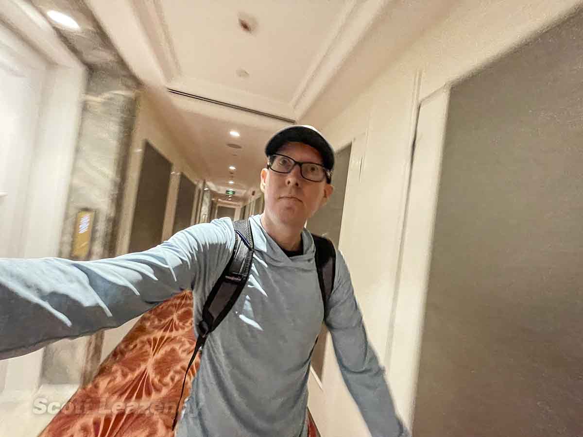 Scott walking through hallway at The Reverie Saigon Hotel