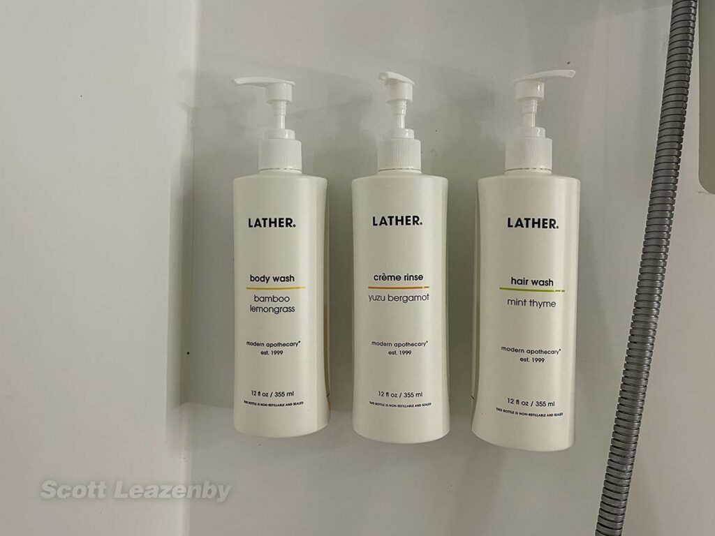 Waikiki Malia Hotel shampoo and conditioner and body wash dispensers in the bathroom