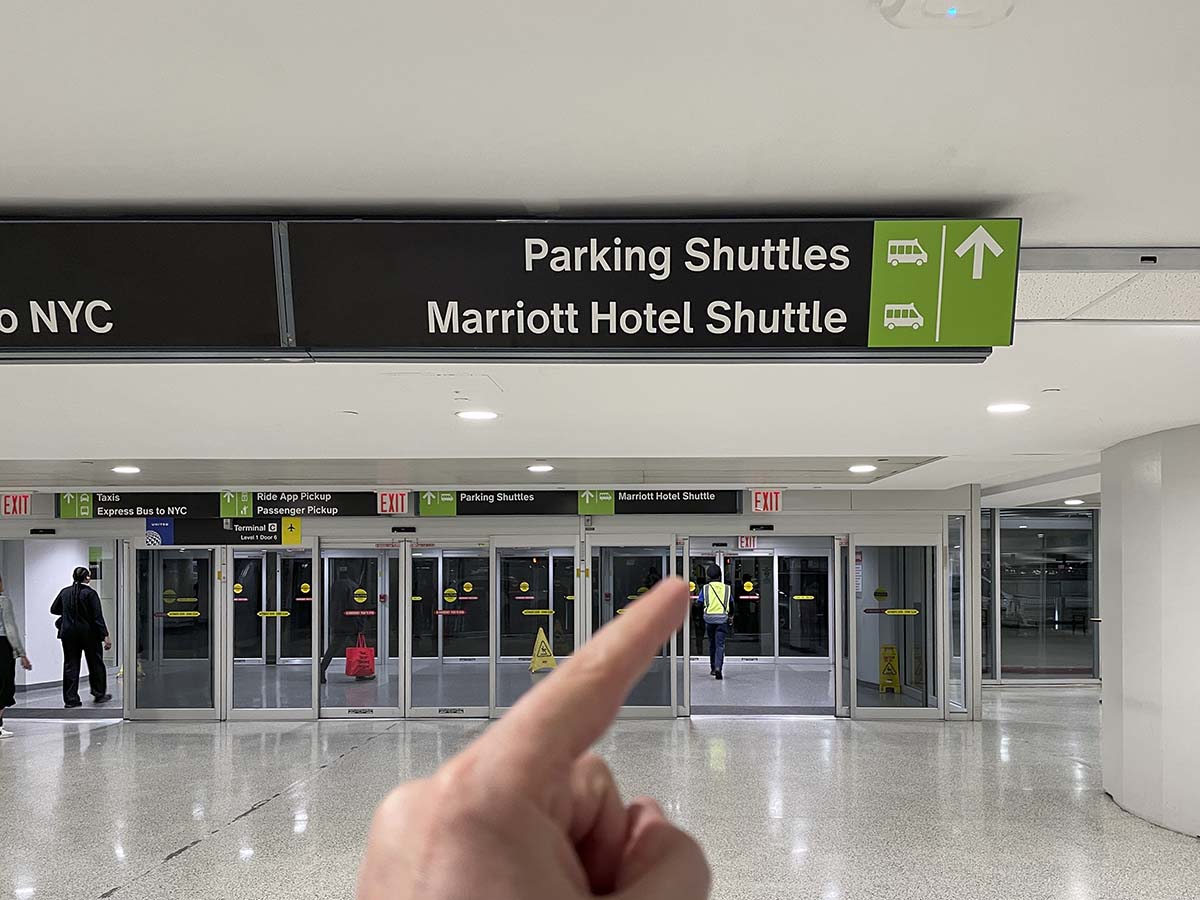 Signs leading to the Marriott hotel shuttle inside the Newark airport