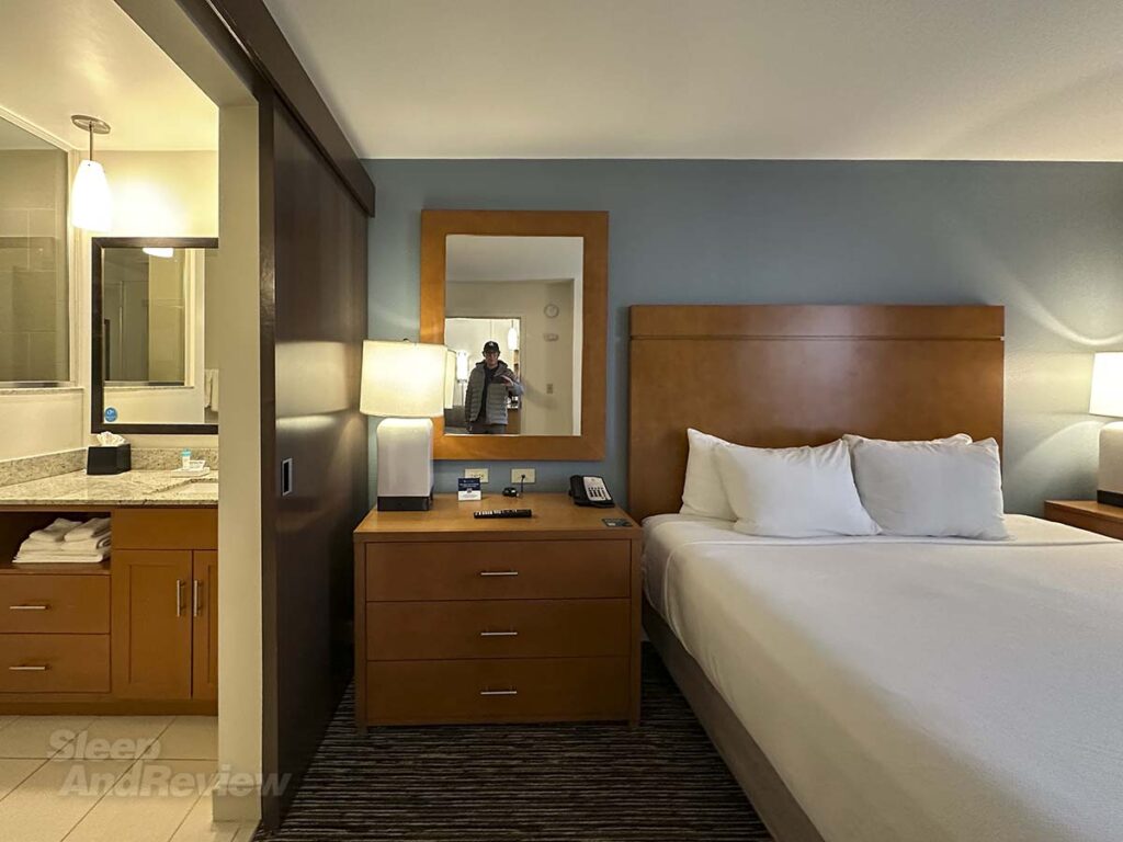 Hyatt House Denver Airport bed and nightstand in the bedroom