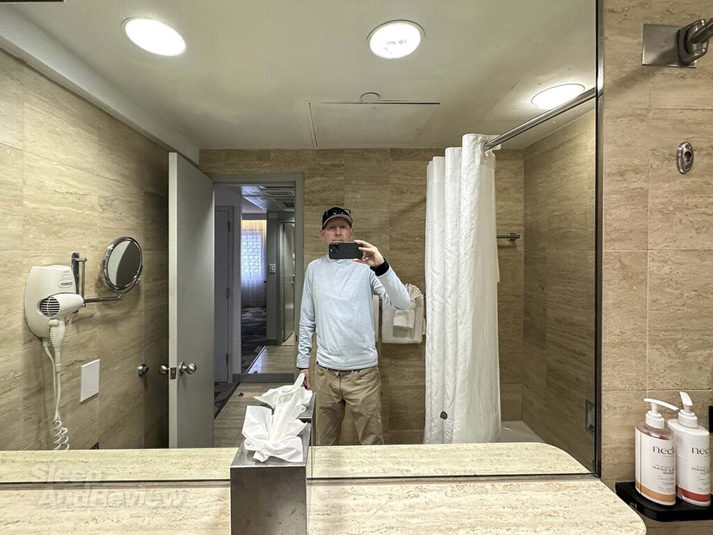 Scott Leazenby standing in the bathroom mirror in his room at the Miami International Airport hotel