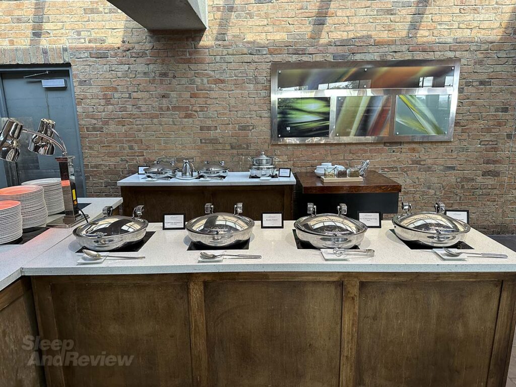 Breakfast buffet featuring hot items such as eggs and sausage and potatoes at the Garden Terrace restaurant Inverness Denver Hotel