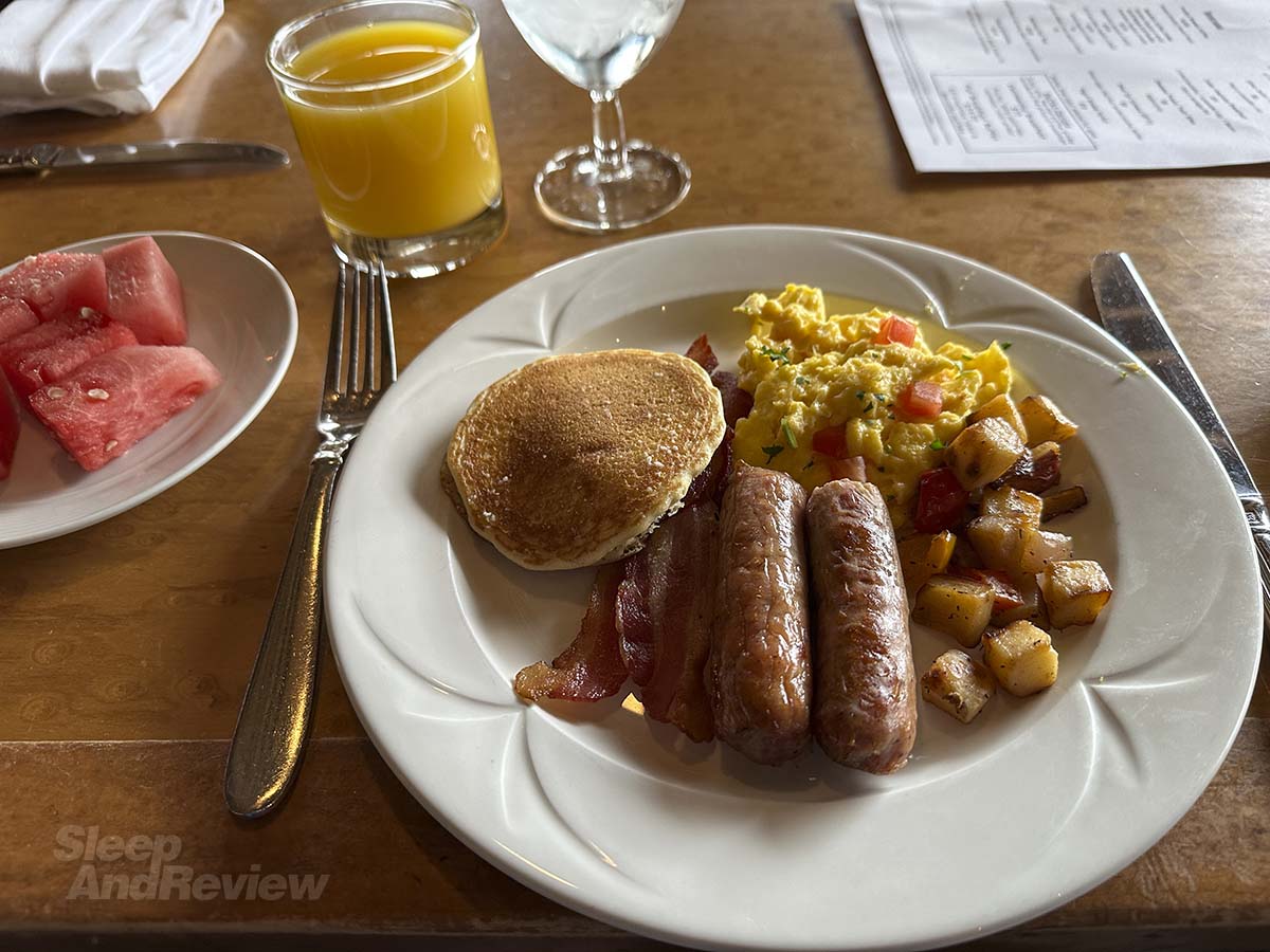 Plate of eggs and sausage and potatoes and pancakes from the breakfast buffet at the Inverness Denver Hotel
