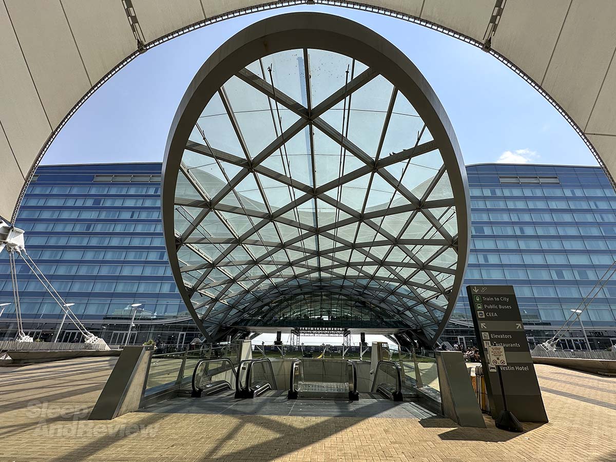 Standing outside the Westin hotel at the Denver airport under the awning leading to both the hotel and transit center
