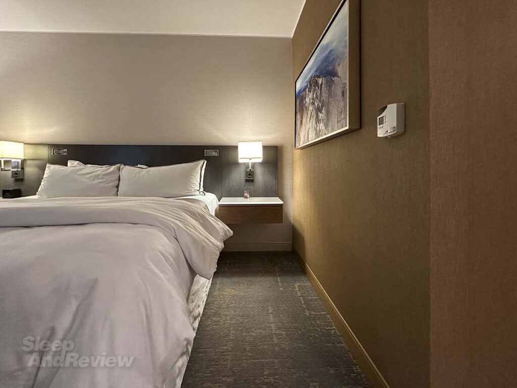 Bedside tables with lamps and artwork on the wall in my room at the Westin Denver airport