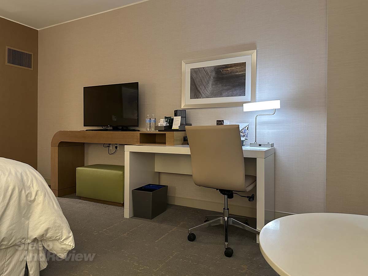 Television with work desk and table in my room at the Western Denver Airport