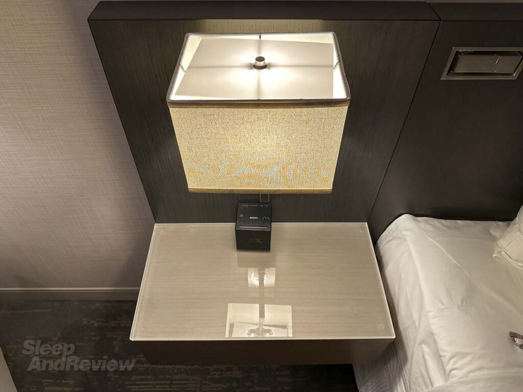 Bedside table with lamp in my room at the Westin Denver airport