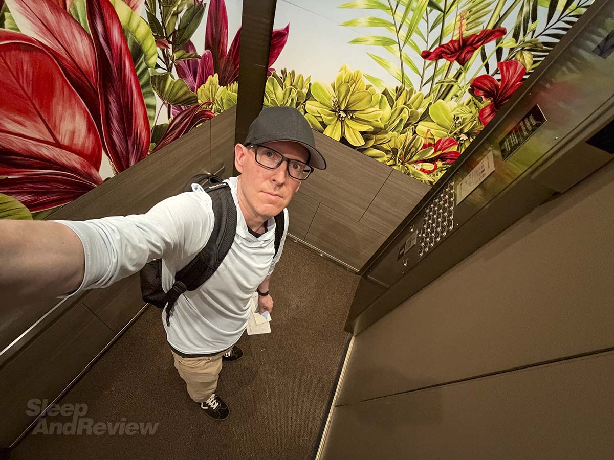 Scott Leazenby writing the elevator up to his room at the Hyatt Regency Waikiki Resort and Spa